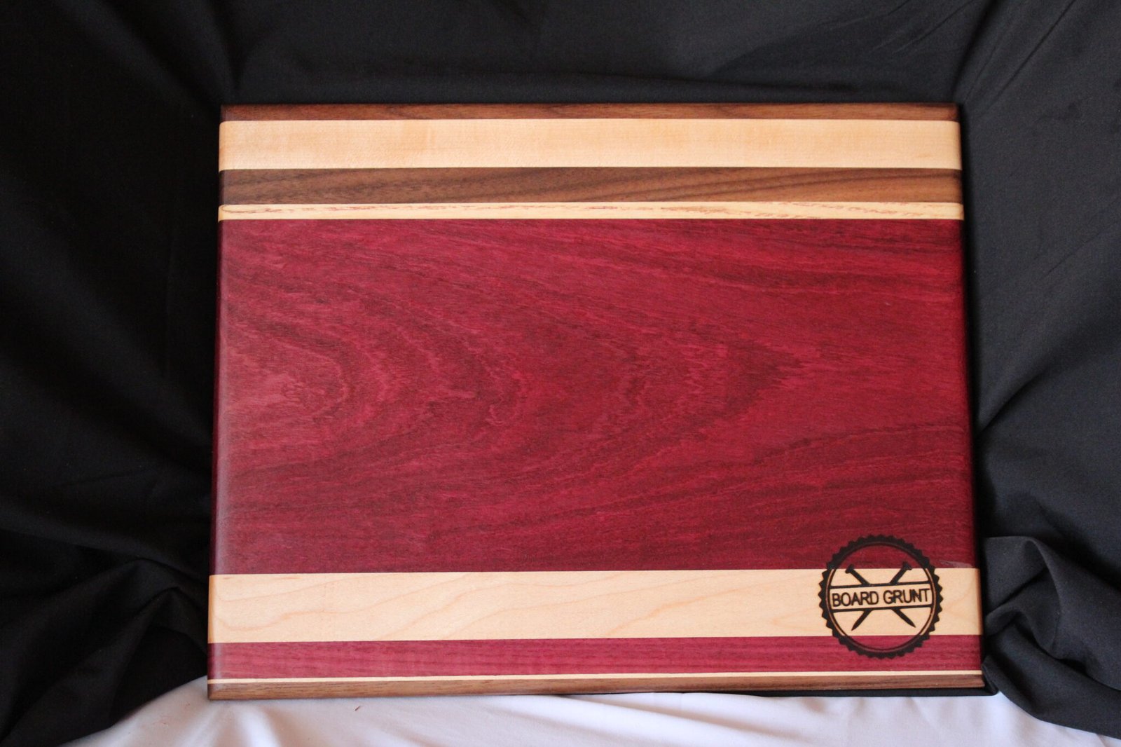 Handmade purpleheart, maple and walnut cutting board by Board Grunt