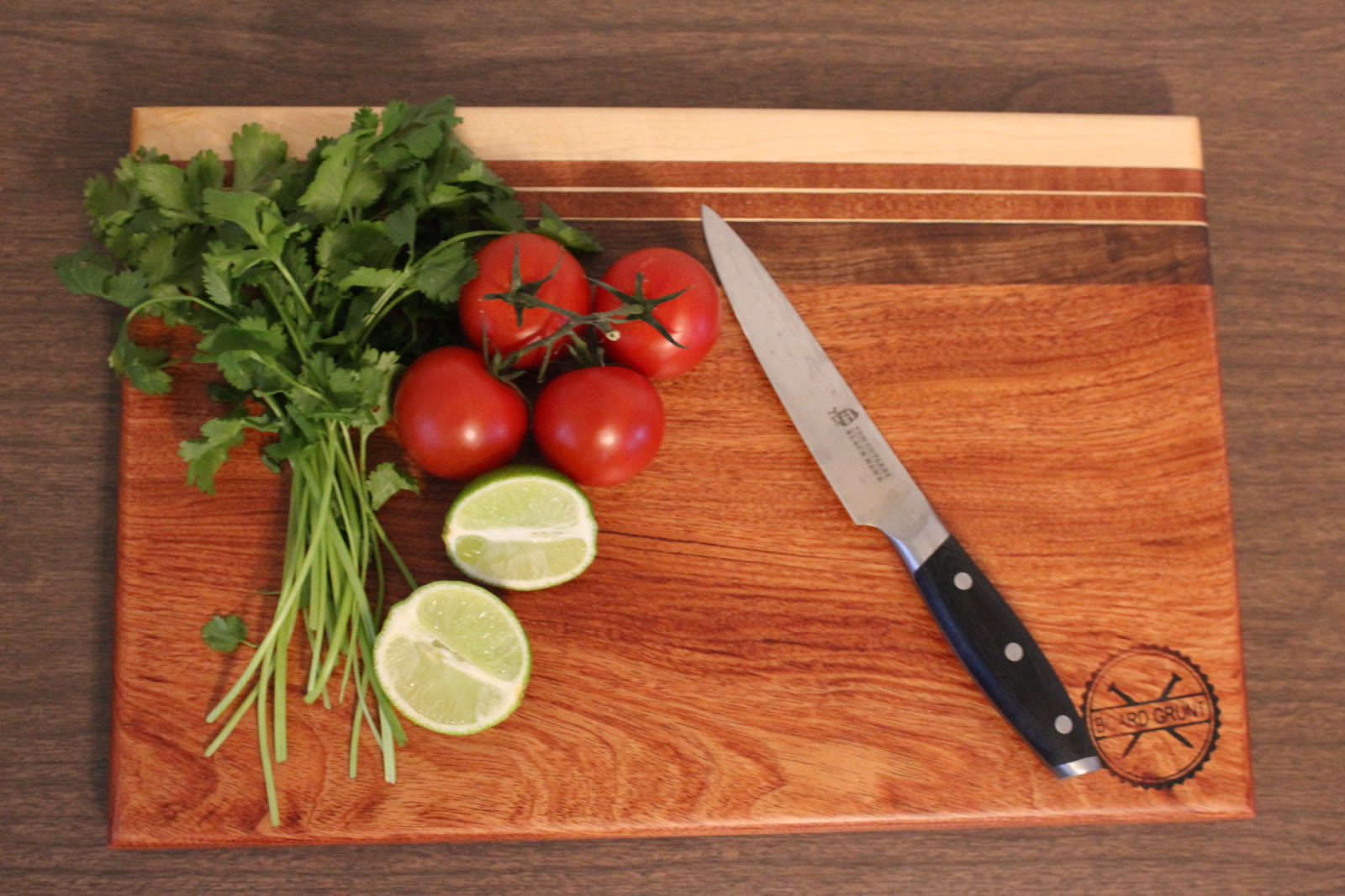 Handmade padauk and maple cutting board with fresh produce