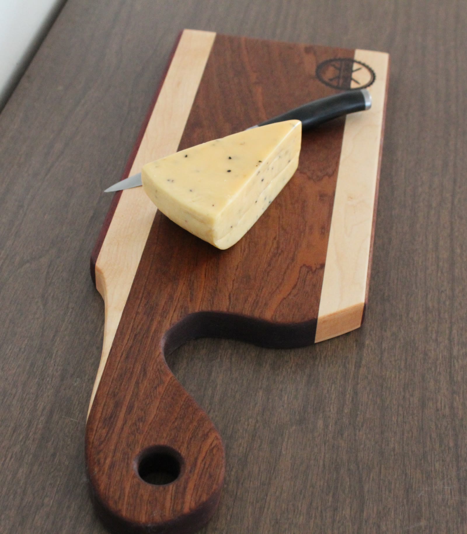 Paddle-handle charcuterie board with cheese