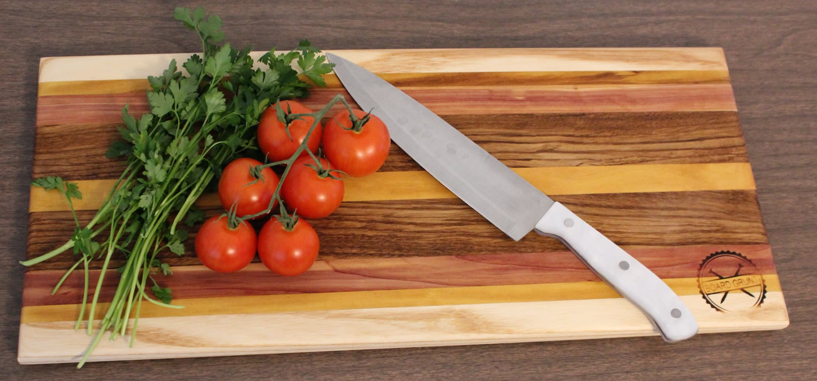 Striped hardwood board with tomatoes and parsley